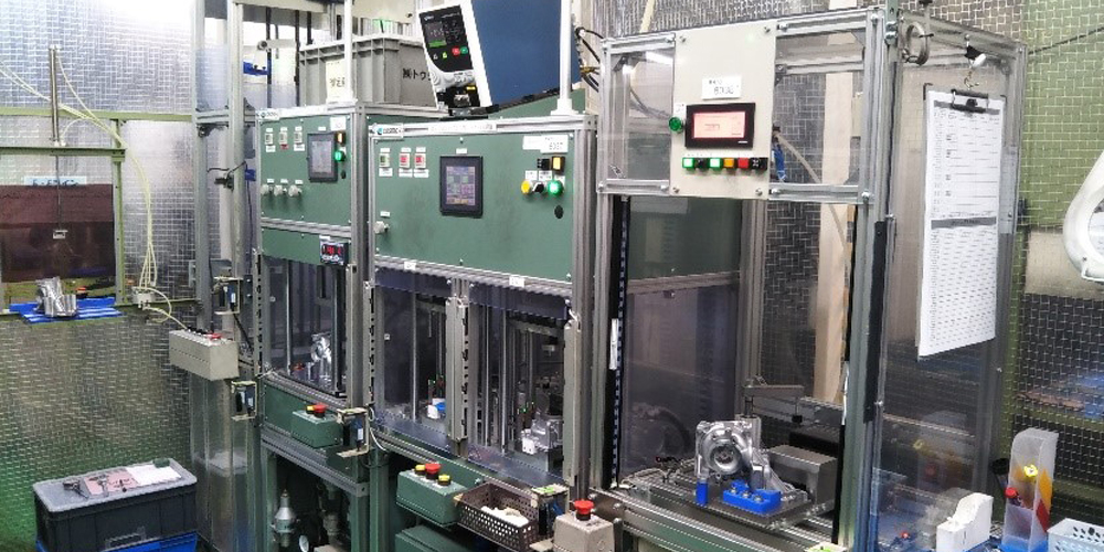 Assembly line (from left, press-fitting machine, Leak tester, Stamping machine)